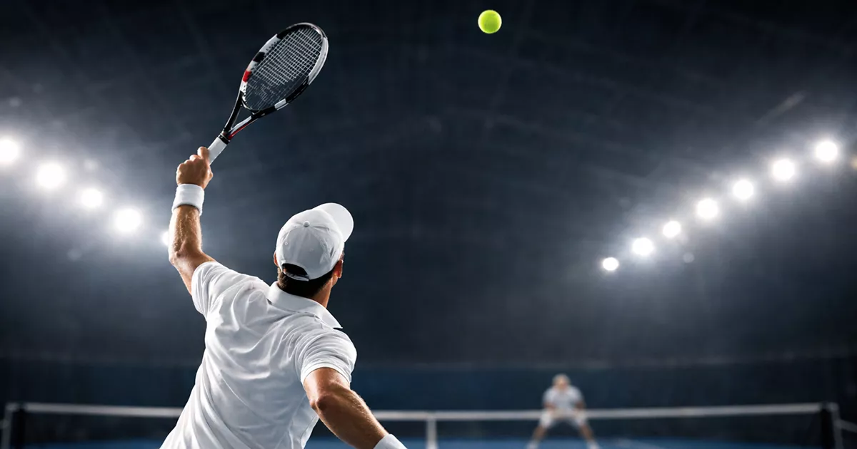Joueur de tennis en plein service puissant sur court en dur avec balle rapide